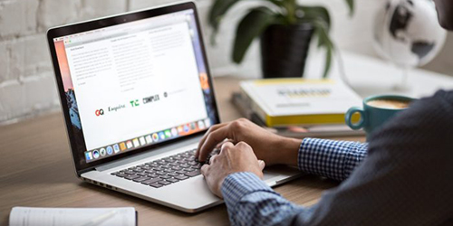 Image of a man sitting at a desk with a laptop