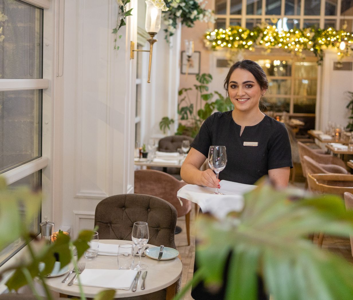 A waitress with an empty glass