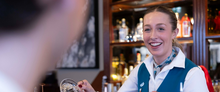 A tour guide smiling in Pearse Lyons Distillery