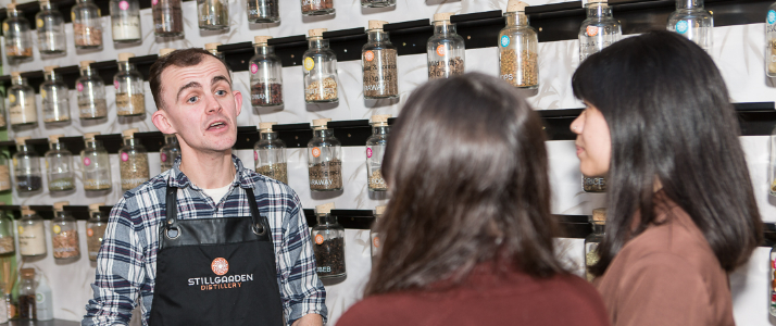 Tour guide staging by botanicals in Stillgarden Distillery