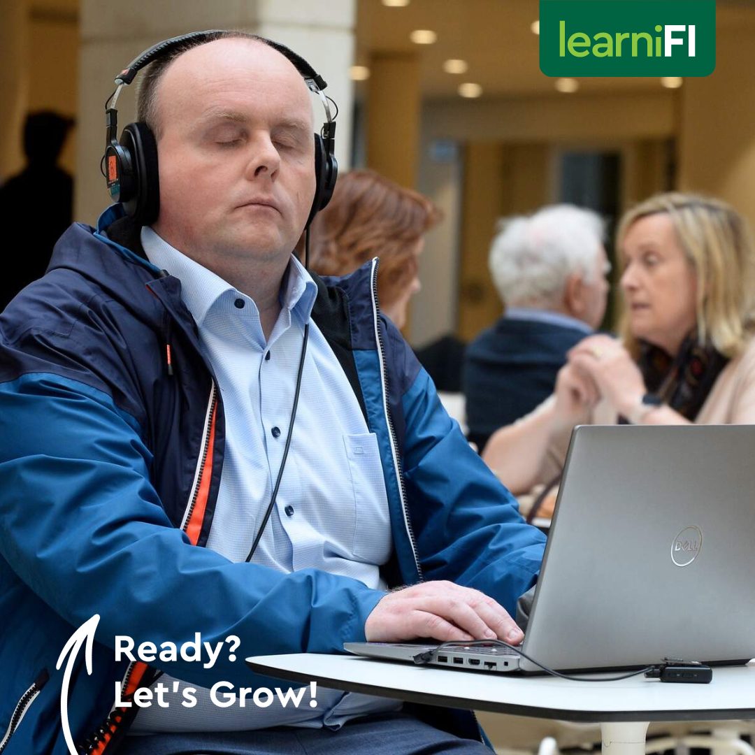 Man sitting at computer using headphones