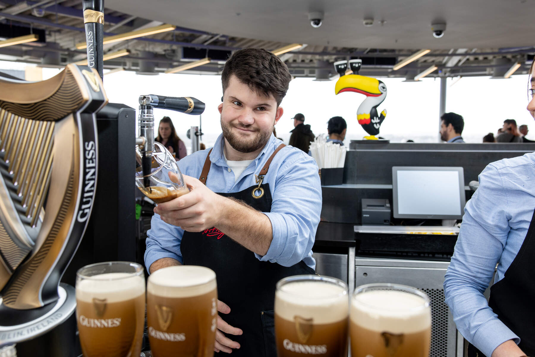 Man pulling a pint of Guinness