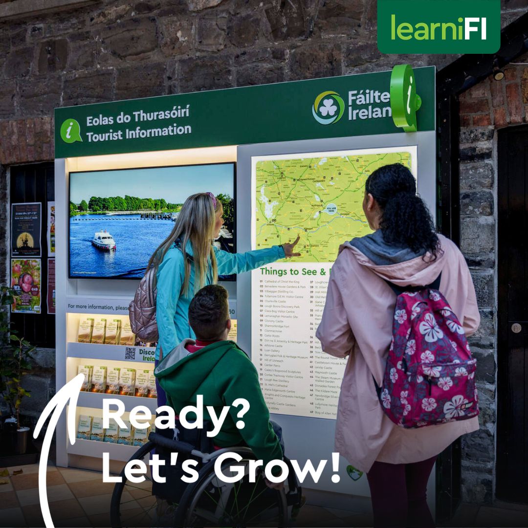 Three people looking at a map on a board on the wall
