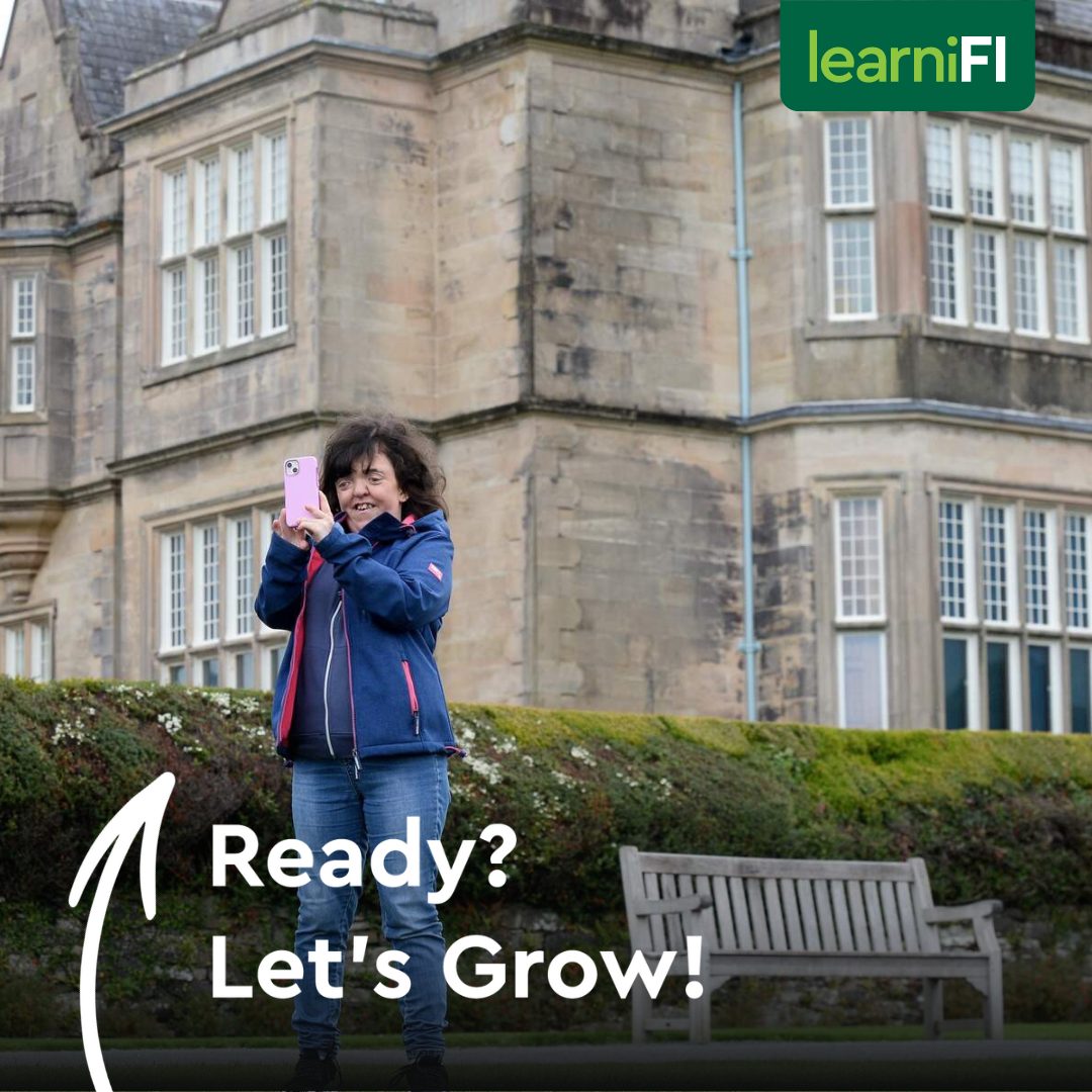 Woman standing in front of a hotel taking a picture