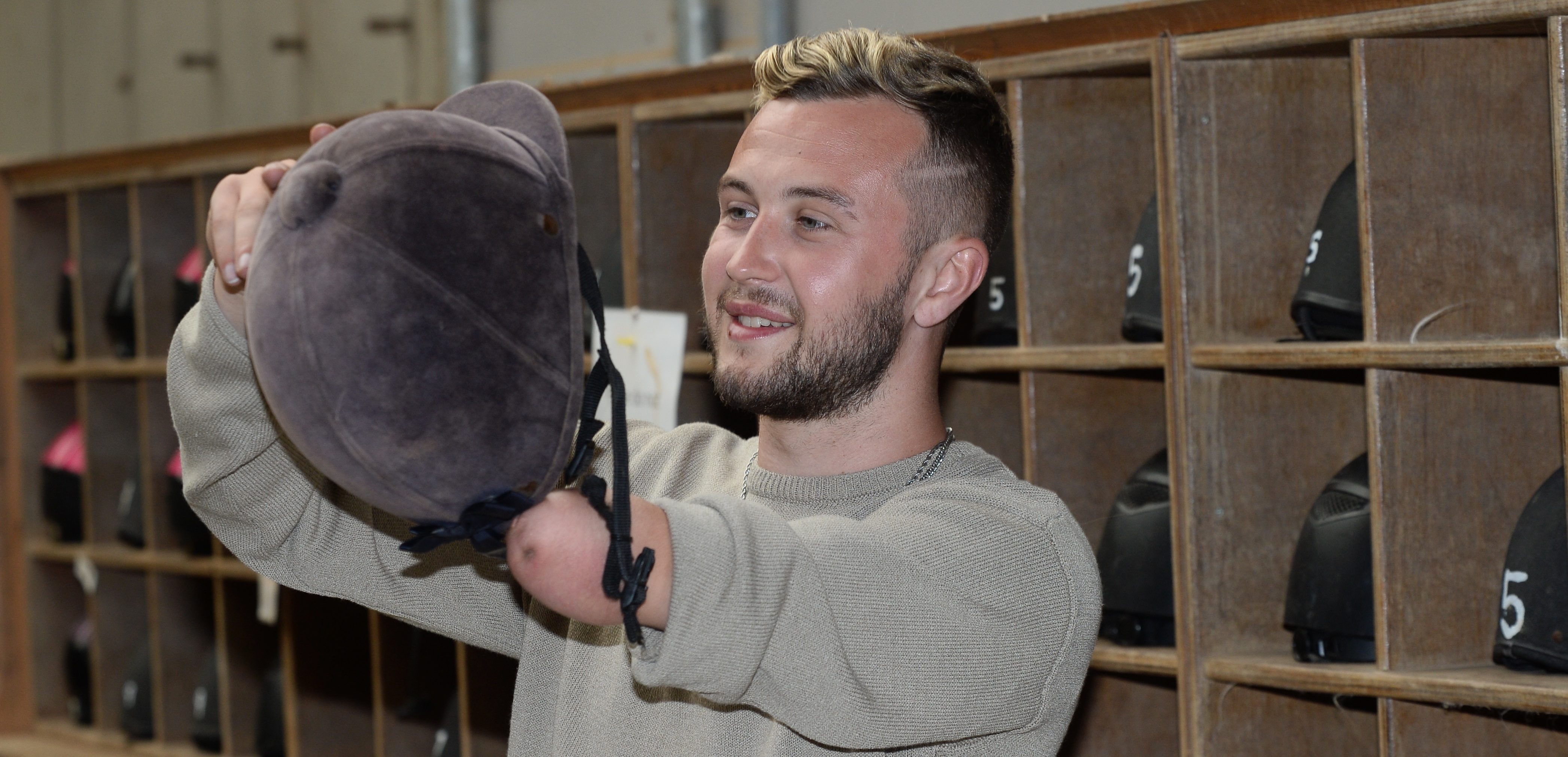 Man putting on helmet