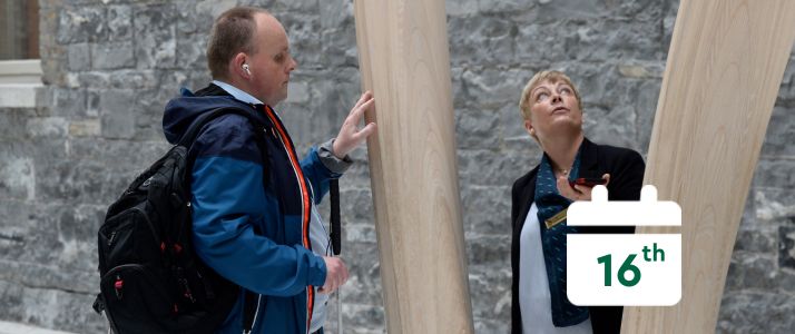 Blind man in the national gallery on a tour with a female tour guide, calendar icon reads 16th