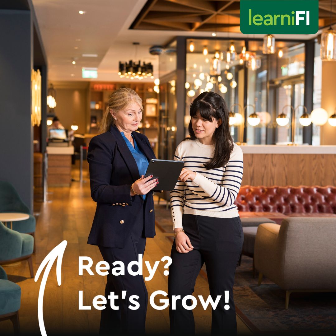 Two colleagues reading a tablet, text reads Ready? Let's Grow!